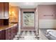 Bathroom with granite counters, tiled floor, and a large soaking tub at 2 Fieldstone Trl, Englewood, CO 80113