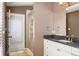 Bathroom featuring granite counters, white cabinetry and glass shower at 2 Fieldstone Trl, Englewood, CO 80113