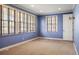 Bright bedroom with ample natural light from multiple windows and neutral carpet at 2 Fieldstone Trl, Englewood, CO 80113