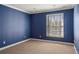 Standard bedroom with blue painted walls and minimal furnishing and carpet floors at 2 Fieldstone Trl, Englewood, CO 80113
