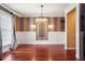 Elegant dining room with hardwood floors, designer wallpaper and decorative lighting at 2 Fieldstone Trl, Englewood, CO 80113