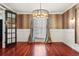 Spacious dining room with rich hardwood floors, chandelier lighting and elegant window treatments at 2 Fieldstone Trl, Englewood, CO 80113