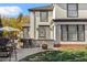 Elegant home exterior with outdoor kitchen and dining, featuring a manicured lawn and well-maintained patio at 2 Fieldstone Trl, Englewood, CO 80113
