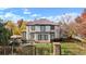 Charming two-story home featuring a patio, manicured lawn, and wrought iron fence, perfect for outdoor entertaining at 2 Fieldstone Trl, Englewood, CO 80113