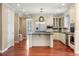 Bright kitchen with stainless appliances, large center island, and custom cabinetry at 2 Fieldstone Trl, Englewood, CO 80113