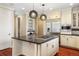 Gourmet kitchen featuring center island, stainless steel appliances, and custom pendant lights at 2 Fieldstone Trl, Englewood, CO 80113