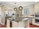Modern kitchen with granite countertops, stainless steel appliances, and island cooktop at 2 Fieldstone Trl, Englewood, CO 80113