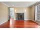 Cozy living room with decorative wallpaper, hardwood flooring, and a fireplace at 2 Fieldstone Trl, Englewood, CO 80113