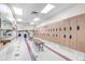 Community locker room with tile flooring, benches, and rows of wooden lockers at 13931 E Marina Dr # 402, Aurora, CO 80014