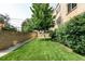 Green backyard with a brick wall and lush bushes at 85 N Ogden St # 34, Denver, CO 80218
