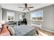 Bright bedroom with windows, a ceiling fan, and a workspace with desk and piano at 85 N Ogden St # 34, Denver, CO 80218