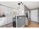 Modern kitchen featuring white cabinets, a breakfast bar, and hardwood floors at 85 N Ogden St # 34, Denver, CO 80218