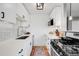 Modern kitchen with white cabinets, a subway tile backsplash, and stainless steel appliances at 85 N Ogden St # 34, Denver, CO 80218