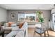 Bright living room area featuring comfortable sectional sofa and a view from a large window at 85 N Ogden St # 34, Denver, CO 80218