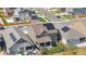 Aerial view of a modern home with solar panels, lush green lawn, and outdoor seating, perfect for entertaining at 864 Clover Loop, Erie, CO 80026