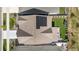 Aerial view of a house with solar panels, backyard with artificial turf, and a patio with seating at 864 Clover Loop, Erie, CO 80026
