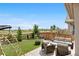 Inviting backyard featuring stylish outdoor furniture, a cozy fire pit, and well-manicured artificial grass at 864 Clover Loop, Erie, CO 80026