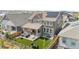 Aerial view of a home showcasing a landscaped backyard with a covered patio and artificial grass at 864 Clover Loop, Erie, CO 80026
