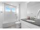 Bright bathroom with a combined bathtub and shower, a toilet, and a vanity with a sink, complemented by a large mirror at 864 Clover Loop, Erie, CO 80026