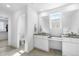 Modern bathroom with double sink and a large mirror at 864 Clover Loop, Erie, CO 80026
