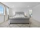 Comfortable bedroom has a large bed with views to the bathroom at 864 Clover Loop, Erie, CO 80026