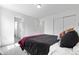 Bright bedroom featuring a comfortable bed, neutral walls, and a convenient closet for ample storage at 864 Clover Loop, Erie, CO 80026