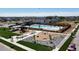 Community pool and playground with surrounding neighborhood, featuring benches and picnic area at 864 Clover Loop, Erie, CO 80026