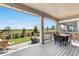 Large, covered deck with outdoor furniture and views of the lush backyard and neighborhood at 864 Clover Loop, Erie, CO 80026