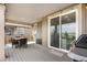 Covered deck features a dining table, sliding glass door, and views of the surrounding landscape at 864 Clover Loop, Erie, CO 80026