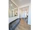 Inviting entryway with a stylish mirror, gray bench, and wood flooring at 864 Clover Loop, Erie, CO 80026