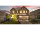 Charming two-story home with a well-maintained front yard, a covered porch, and an attached two-car garage at 864 Clover Loop, Erie, CO 80026