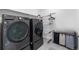 Modern laundry room with high-end washer and dryer, and convenient storage, making laundry tasks easier at 864 Clover Loop, Erie, CO 80026