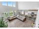 Open-concept living area with ample natural light and hardwood floors at 864 Clover Loop, Erie, CO 80026