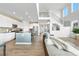 Open concept living space combining a modern kitchen and a comfortable living area, perfect for entertaining at 864 Clover Loop, Erie, CO 80026