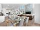 Bright and airy living space featuring an open-concept design connecting the kitchen, dining area, and living room at 864 Clover Loop, Erie, CO 80026