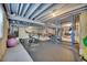 Basement gym area with rubber flooring, exposed joists, exercise bike and weight rack at 877 Eldorado Dr, Superior, CO 80027