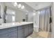 Bathroom featuring a double sink vanity with a large mirror and a shower tub combo at 877 Eldorado Dr, Superior, CO 80027
