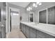 Well-lit bathroom with a double sink vanity with updated cabinets, tile floor and tub with shower at 877 Eldorado Dr, Superior, CO 80027