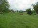 Expansive community park with a walking path, playground, bench, and lush green grass at 877 Eldorado Dr, Superior, CO 80027