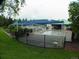 Community pool area with shade coverings, pool furniture, fenced perimeter, and adjacent lawn at 877 Eldorado Dr, Superior, CO 80027