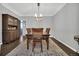 Charming dining room features dark hardwood floors, an elegant light fixture, and a wooden china cabinet at 877 Eldorado Dr, Superior, CO 80027