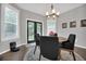Bright dining room boasts a modern chandelier and French doors leading to the backyard at 877 Eldorado Dr, Superior, CO 80027