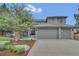 Charming two-story home boasts a three-car garage, well-maintained landscaping, and mature shade tree in the front yard at 877 Eldorado Dr, Superior, CO 80027