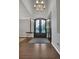 Grand foyer features an elegant chandelier, high ceilings, beautiful hardwood floors, and custom iron double doors at 877 Eldorado Dr, Superior, CO 80027