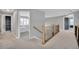 Second floor hallway with neutral tones and natural wood railing leading to the bedrooms at 877 Eldorado Dr, Superior, CO 80027