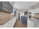 Expansive kitchen features an island, granite countertops, and white and blue cabinetry at 877 Eldorado Dr, Superior, CO 80027