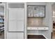 Built-in kitchen desk with cabinets, drawers, and counter space, adjacent to the refrigerator at 877 Eldorado Dr, Superior, CO 80027