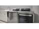 Laundry room featuring modern stainless steel washer and dryer, plus countertop and sink at 877 Eldorado Dr, Superior, CO 80027