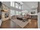 Bright living room boasts soaring ceilings, large windows, a stone fireplace, and open-concept design at 877 Eldorado Dr, Superior, CO 80027