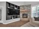 Inviting living room features a stone fireplace, dark built-in bookshelves, and hardwood floors at 877 Eldorado Dr, Superior, CO 80027